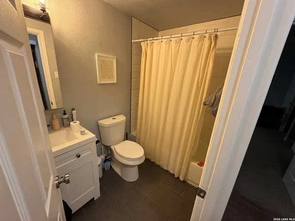 a bathroom with a toilet a sink and a mirror