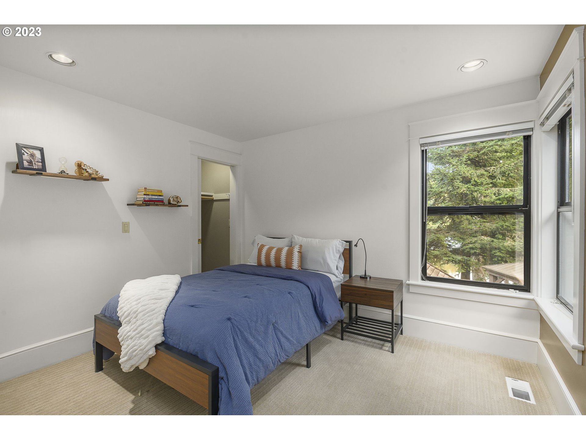 224 Southwest Forest Cove Road West Linn, OR 97068 - Photo 22 of 36 a bedroom with a bed and a large window