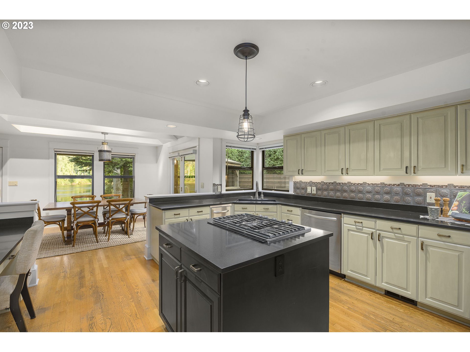 224 Southwest Forest Cove Road West Linn, OR 97068 - Photo 7 of 36 a kitchen with a counter top space a sink stainless steel appliances and cabinets