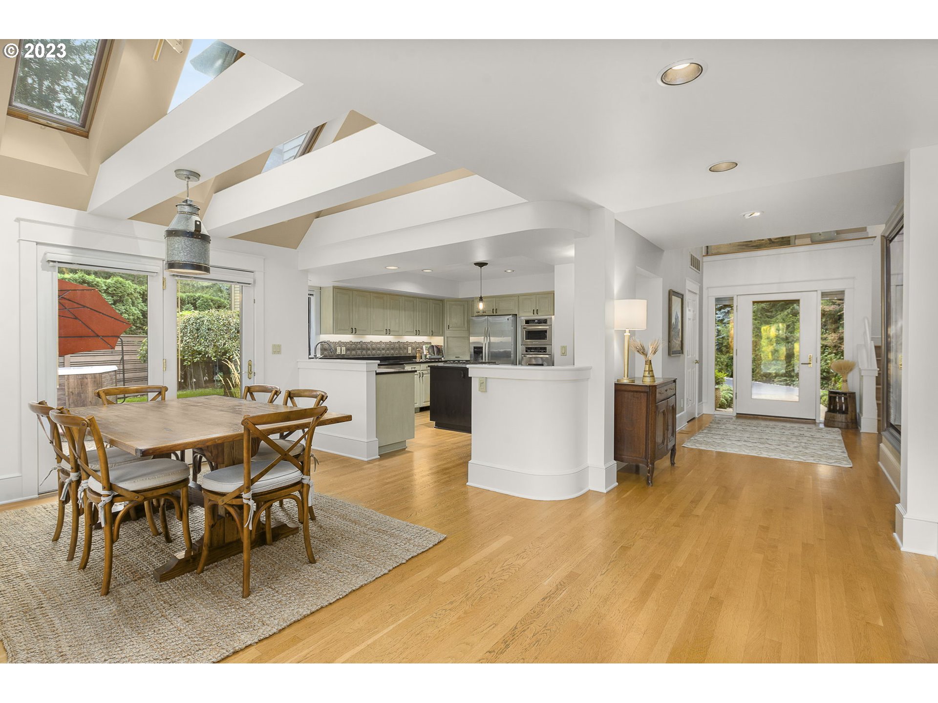 224 Southwest Forest Cove Road West Linn, OR 97068 - Photo 10 of 36 a living room with furniture wooden floor and kitchen view