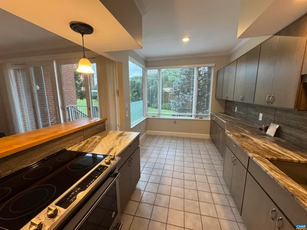 a large kitchen with kitchen island a sink stainless steel appliances and cabinets