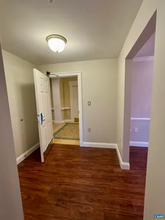a view of a room with wooden floor and chandelier