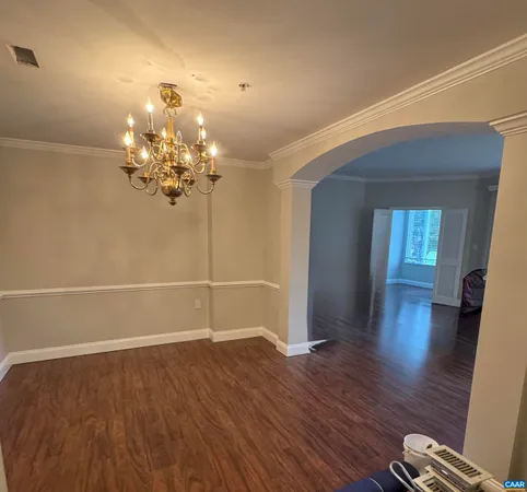 a view of a room with wooden floor and fan