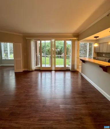 a view of a living room with wooden floor