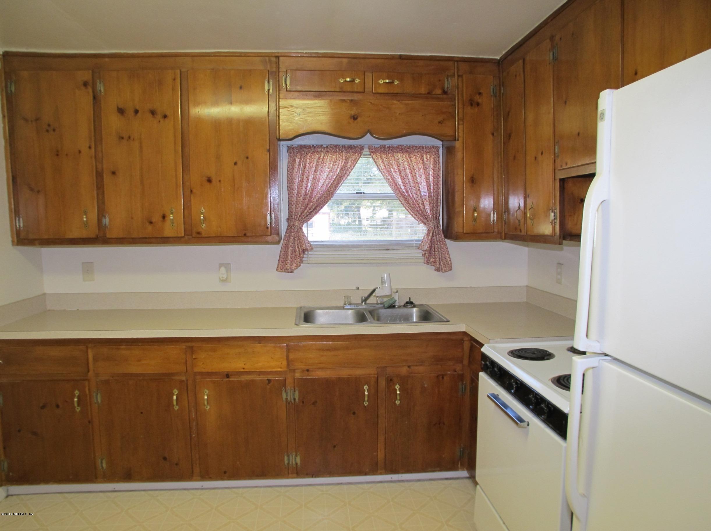 10593 Joes Road Jacksonville, FL 32221 - Photo 11 of 21 a kitchen with a sink a stove and cabinets