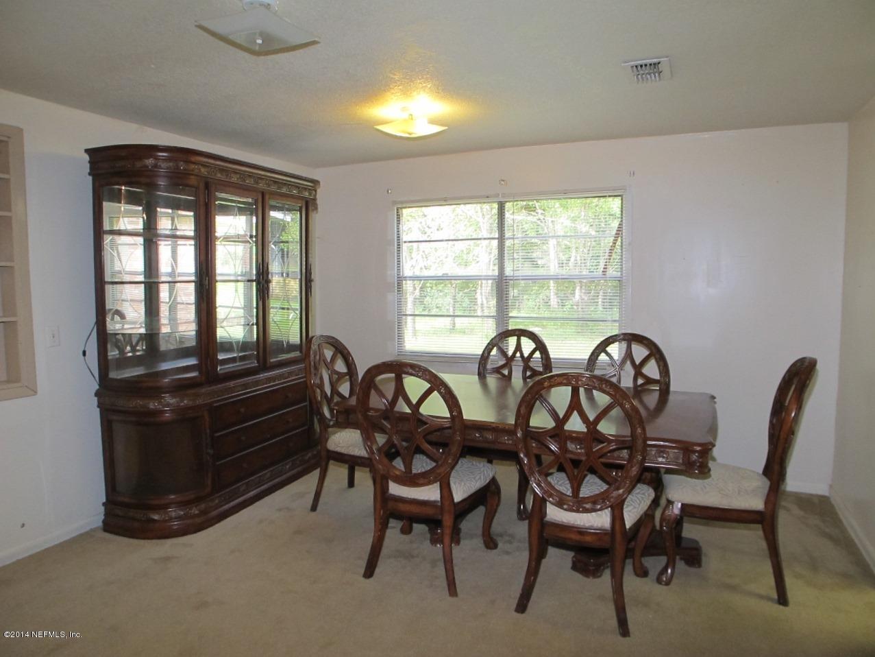 10593 Joes Road Jacksonville, FL 32221 - Photo 8 of 21 a view of a dining room with furniture and windows