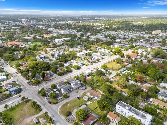 an aerial view of residential building with outdoor space and ocean