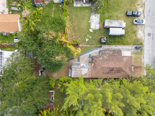 an aerial view of a house with a yard