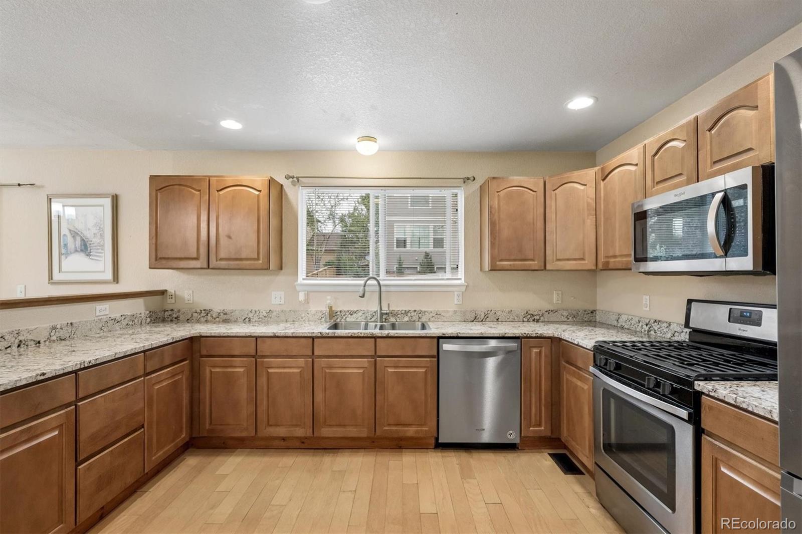 557 West Stellars Jay Drive Highlands Ranch, CO 80129 - Photo 13 of 41 a kitchen with a sink stove and microwave