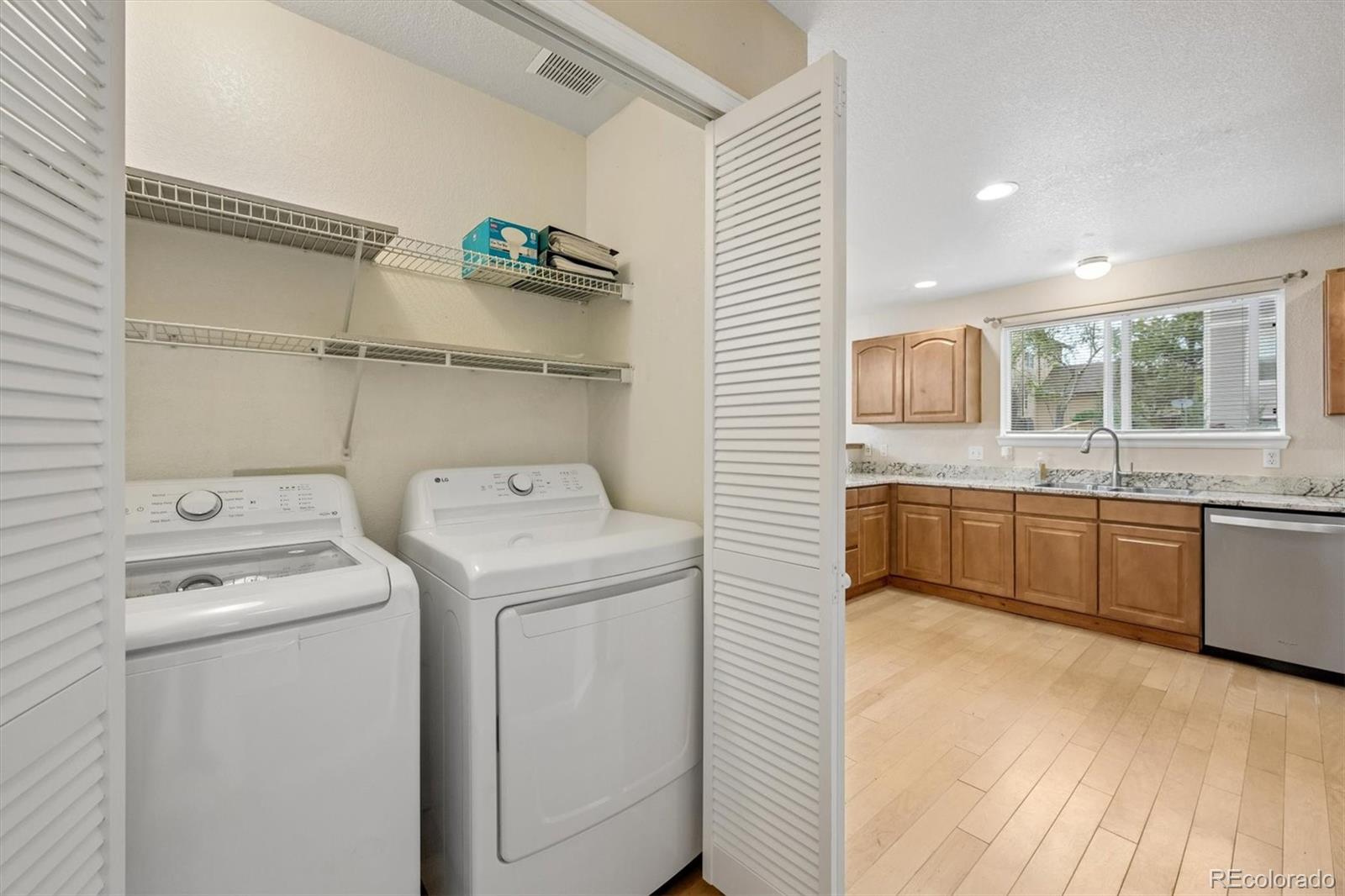 557 West Stellars Jay Drive Highlands Ranch, CO 80129 - Photo 16 of 41 a view of washer and dryer with wooden floor
