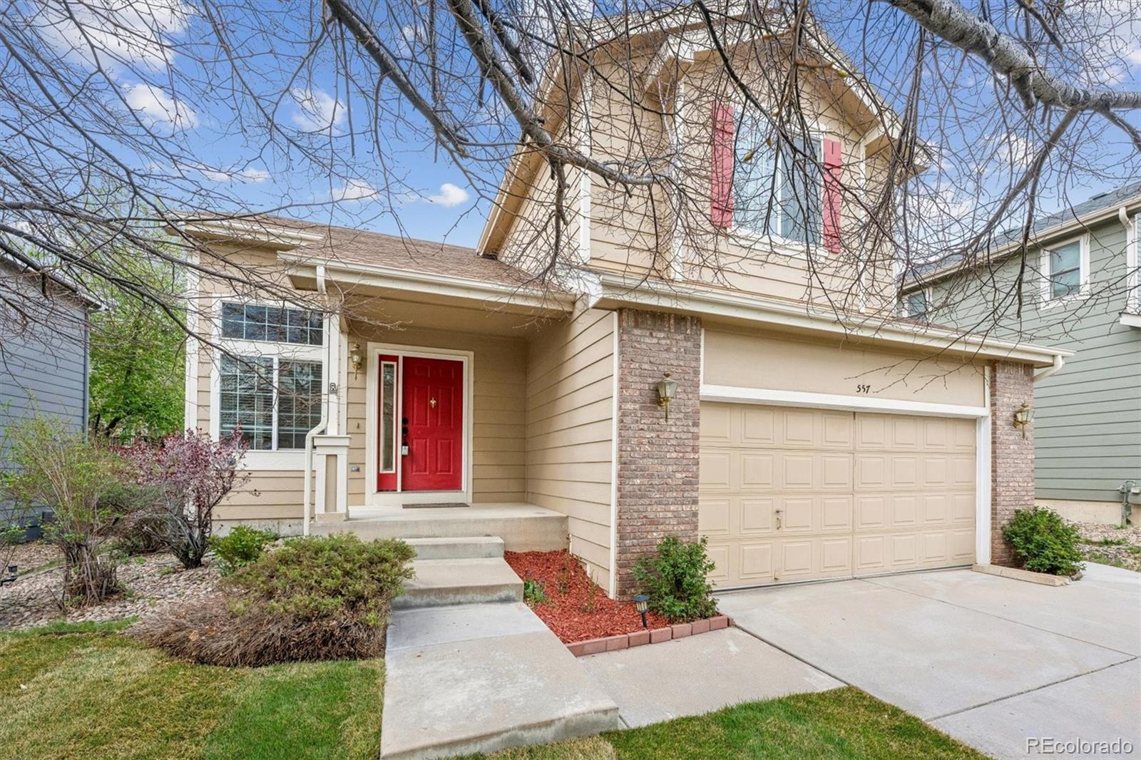 557 West Stellars Jay Drive Highlands Ranch, CO 80129 - Photo 2 of 41 a front view of a house with garden