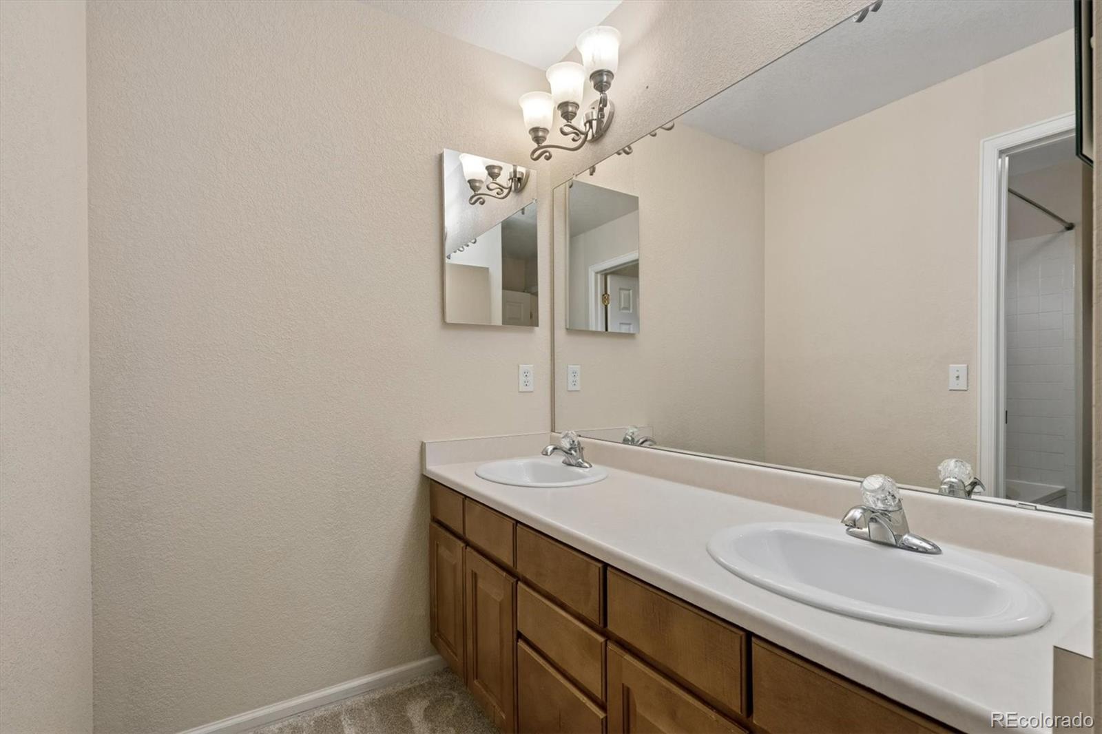 557 West Stellars Jay Drive Highlands Ranch, CO 80129 - Photo 21 of 41 a bathroom with a sink vanity and a mirror