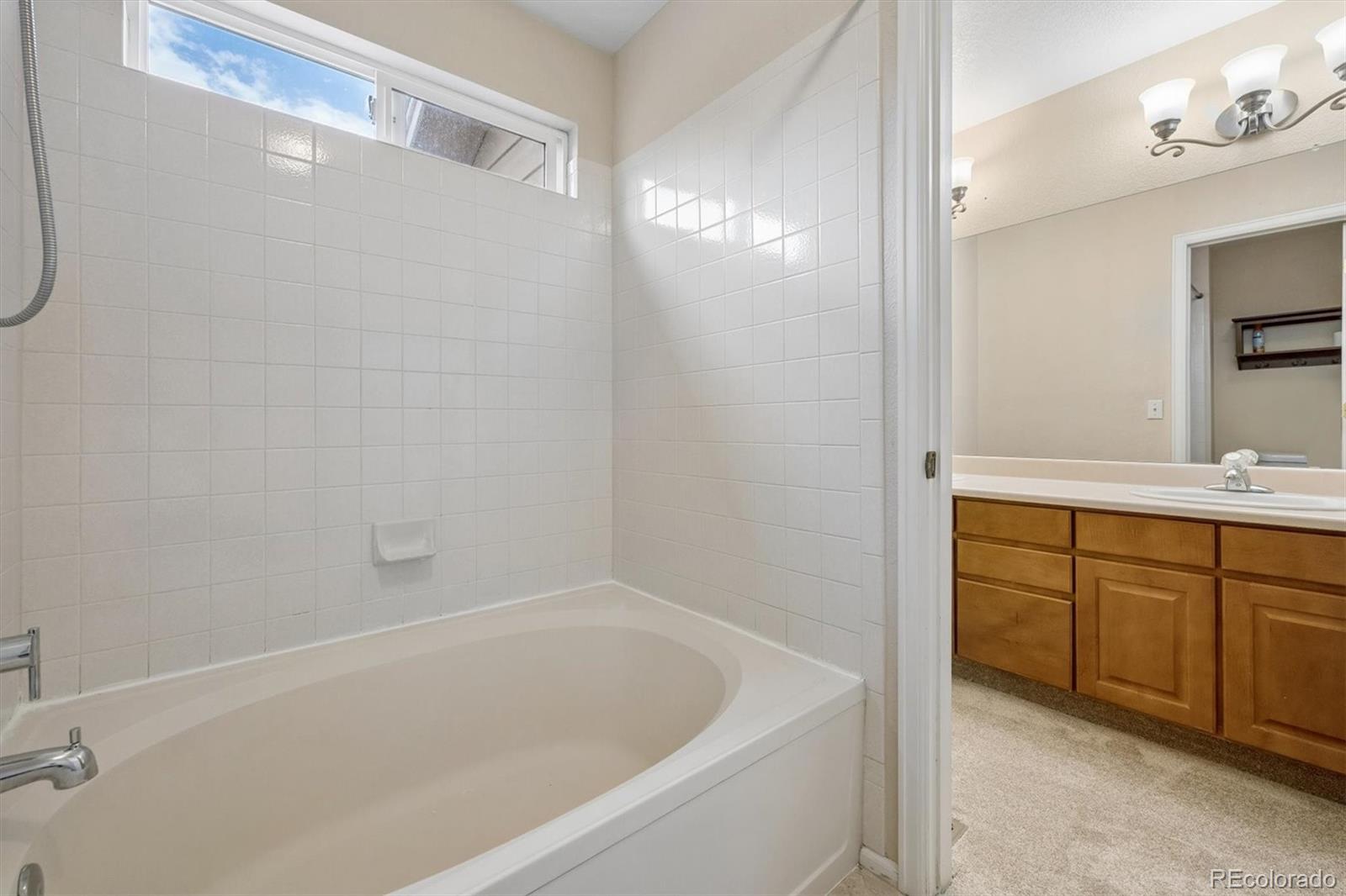 557 West Stellars Jay Drive Highlands Ranch, CO 80129 - Photo 22 of 41 a bathroom with a tub sink vanity and granite