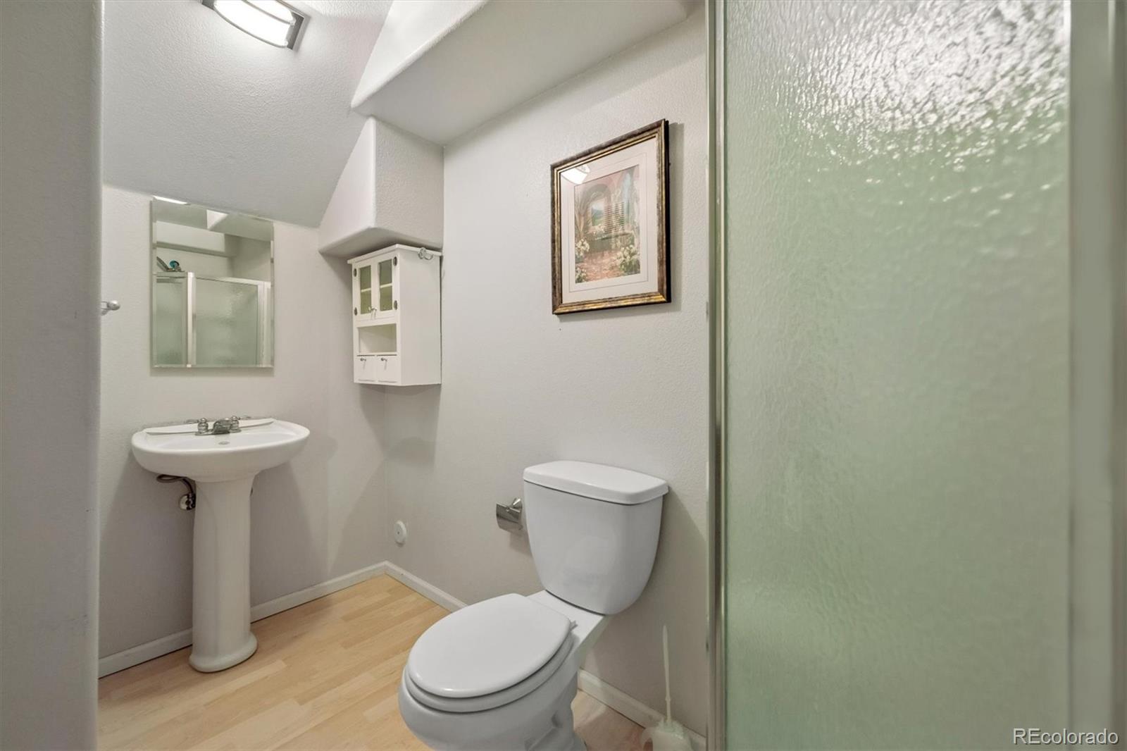 557 West Stellars Jay Drive Highlands Ranch, CO 80129 - Photo 28 of 41 a white toilet sitting next to a bathroom sink