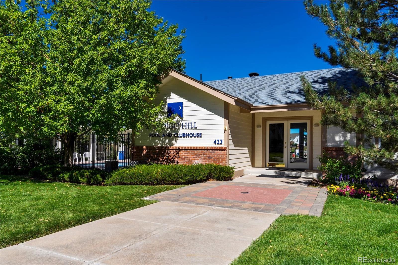557 West Stellars Jay Drive Highlands Ranch, CO 80129 - Photo 36 of 41 a front view of a house with a yard and trees