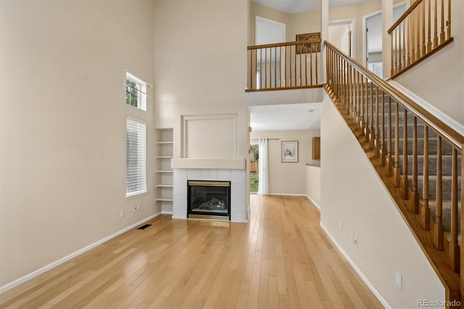 557 West Stellars Jay Drive Highlands Ranch, CO 80129 - Photo 6 of 41 a view of livingroom and fireplace with wooden floor