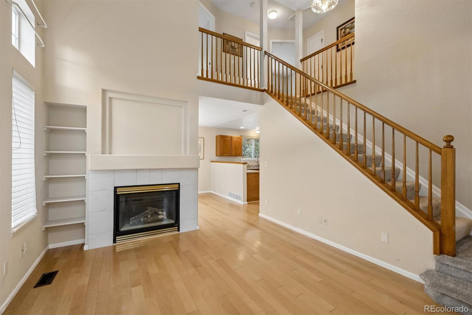 557 West Stellars Jay Drive Highlands Ranch, CO 80129 - Photo 7 of 41 a view of a livingroom with a fireplace stairs and a couch