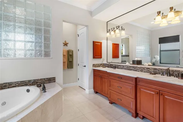 a spacious bathroom with a double vanity sink mirror double and bathtub