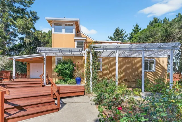 a view of a patio with table and chairs and potted plants