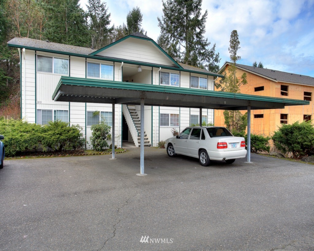 3919 Mason Loop Road Tacoma, WA 98409 - Photo 2 of 20 a car parked in front of a house