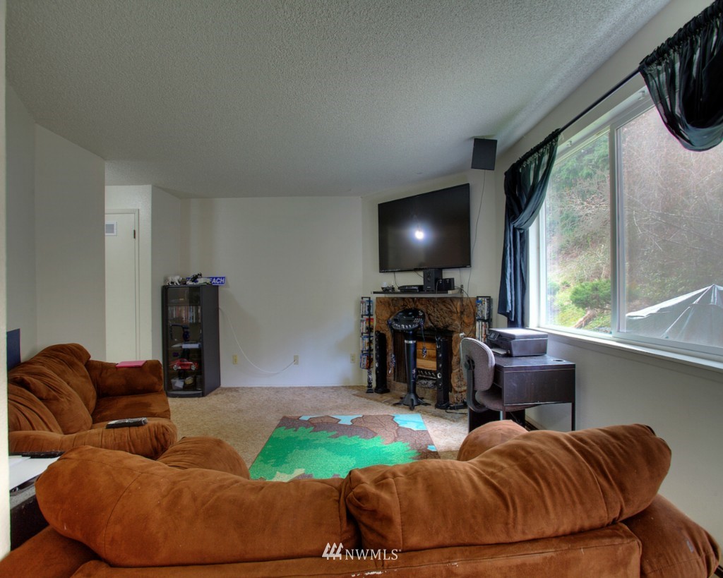 3919 Mason Loop Road Tacoma, WA 98409 - Photo 13 of 20 a living room with furniture and a flat screen tv