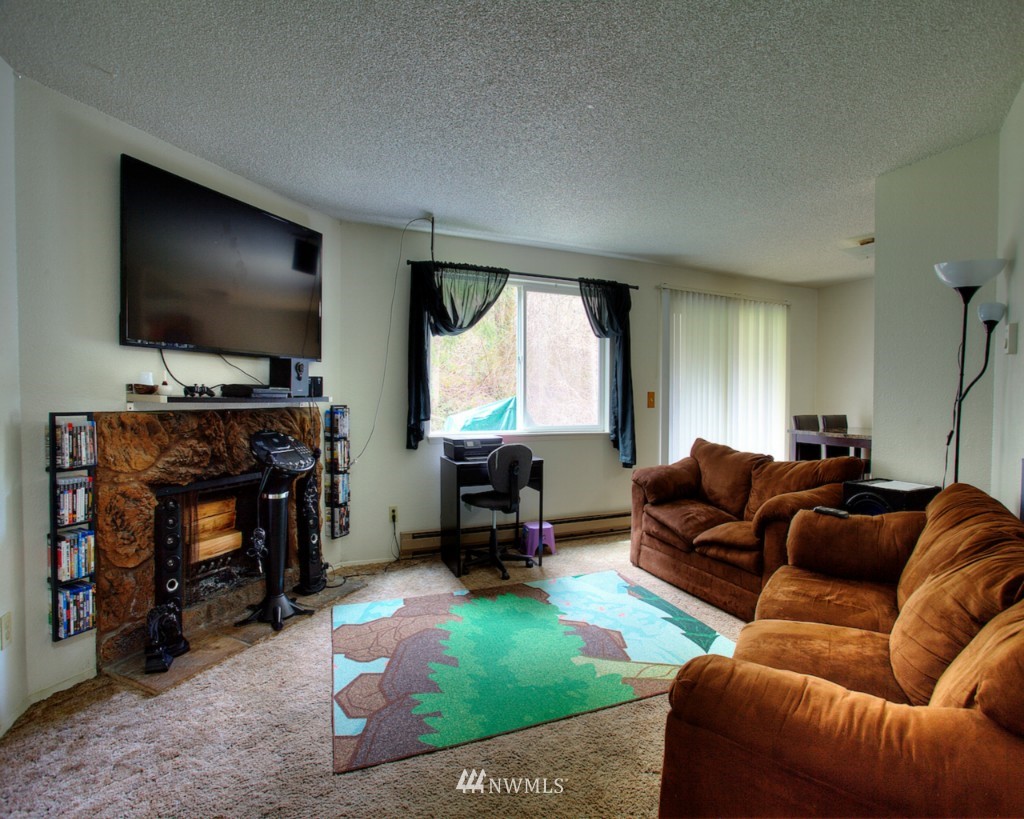 3919 Mason Loop Road Tacoma, WA 98409 - Photo 14 of 20 a living room with furniture and a flat screen tv