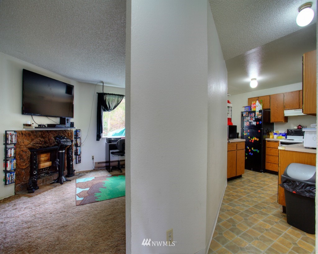 3919 Mason Loop Road Tacoma, WA 98409 - Photo 15 of 20 a living room with furniture and a flat screen tv
