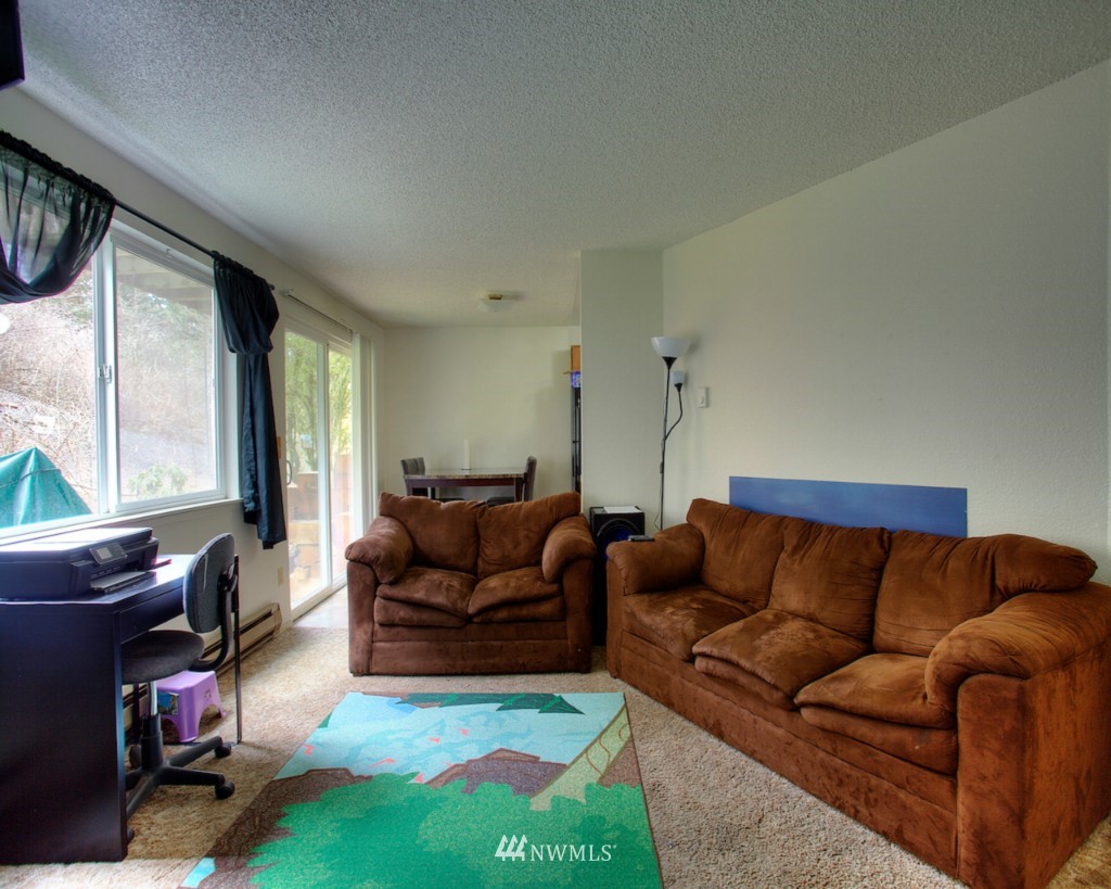 3919 Mason Loop Road Tacoma, WA 98409 - Photo 20 of 20 a living room with furniture and a flat screen tv