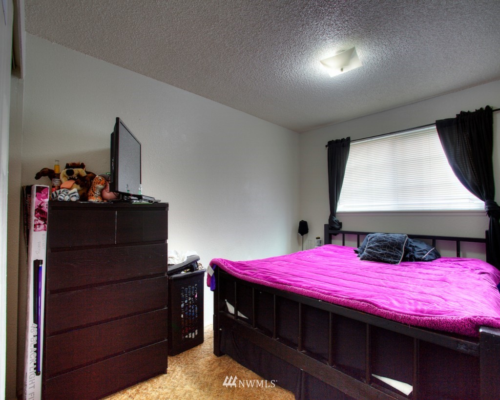 3919 Mason Loop Road Tacoma, WA 98409 - Photo 8 of 20 a bedroom with a bed and window