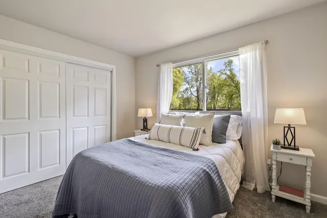 a patio with wooden floor and outdoor seating