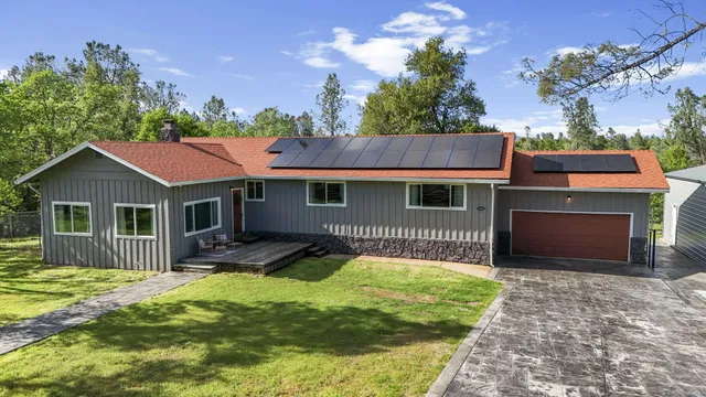 a view of a patio with table and chairs and potted plants