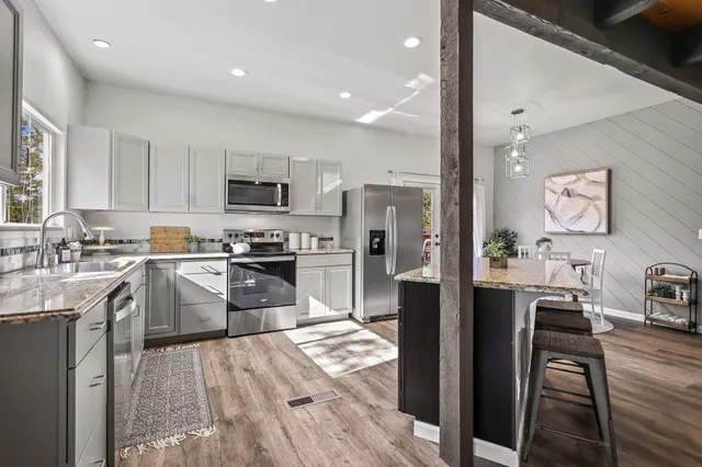 a front view of a house with a garden and yard