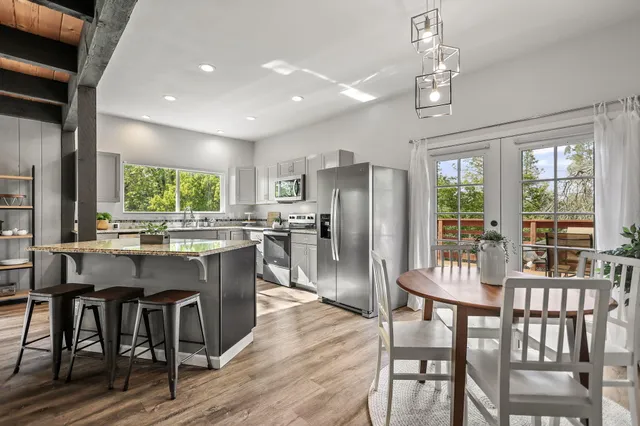 a view of a dining room with furniture and wooden floor