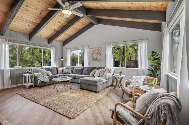 a living room with furniture wooden floor and a fireplace