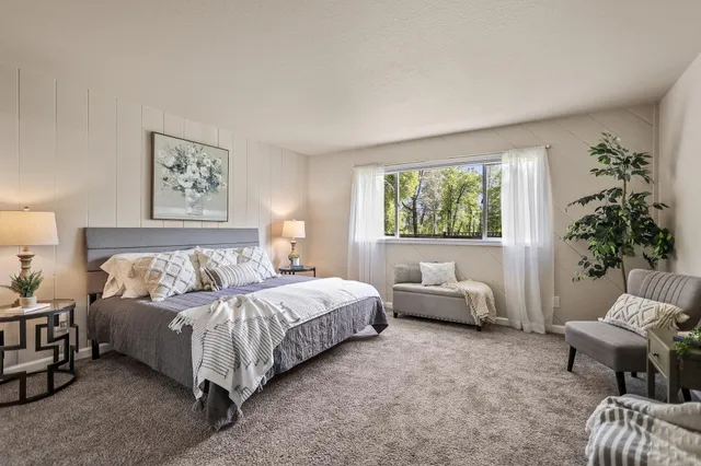 a bathroom with a granite countertop sink a mirror and a shower