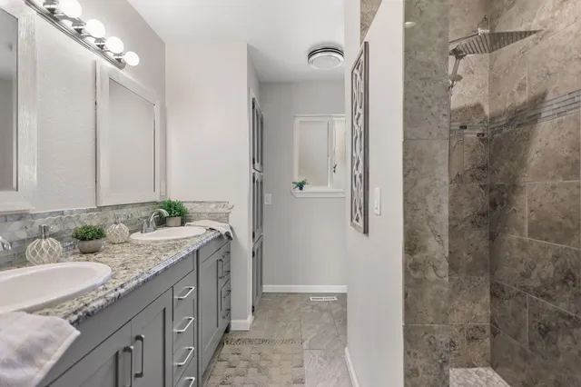 a bedroom with a bed and a dresser next to a window