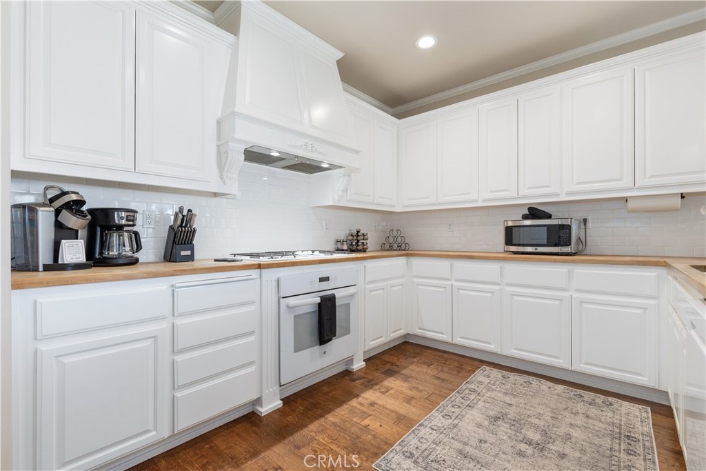 669 Red Cloud Road Paso Robles, CA 93446 - Photo 14 of 61 a kitchen with white cabinets and white appliances