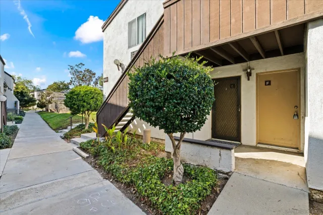 a view of a house with pool and chairs