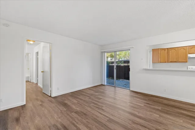 a view of wooden floor and windows in a room