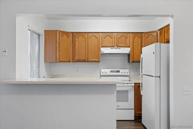 a kitchen with a refrigerator and a sink