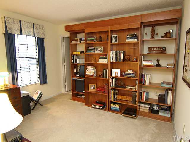 7753 Falcon Rest Circle Raleigh, NC 27615 - Photo 11 of 15 What a bonus! Believe it or not, you are looking at a Murphy Bed. The center panels open up to reveal a drop down bed, complete with mattress and lighting. This arrangement provides versatility -office space and complete guest quarters in the same room.