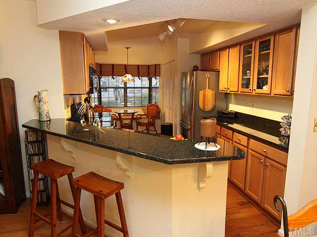 7753 Falcon Rest Circle Raleigh, NC 27615 - Photo 5 of 15 Completely remodeled eat-in kitchen. Granite countertops, stainless steel appliances, and a stainless undermount sink. The refrigerator conveys, as does the washer and dryer.