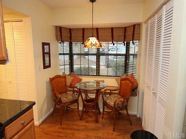 7753 Falcon Rest Circle Raleigh, NC 27615 - Photo 7 of 15 A perfect spot for your morning coffee. The bi-fold doors open into the laundry/storage area. There is additional closet space and a half bath through the hallway to the left. New custom blinds throughout the home.