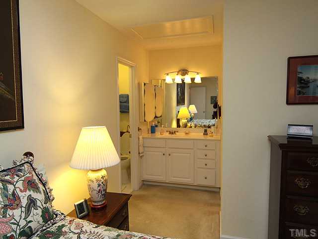 7753 Falcon Rest Circle Raleigh, NC 27615 - Photo 10 of 15 The Master Suite also has a vanity area which has updated cabinetry, countertop, sink, and lighting on a dimmer. Separate toilet and shower area to the left, and a large updated walk in closet to the right.