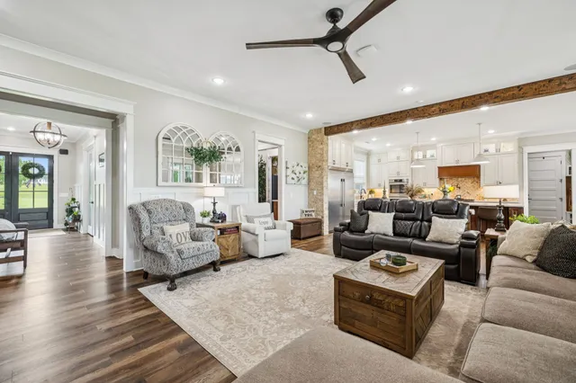 a kitchen with granite countertop a dining table chairs and white cabinets