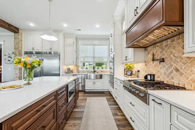a kitchen with a sink stove and cabinets