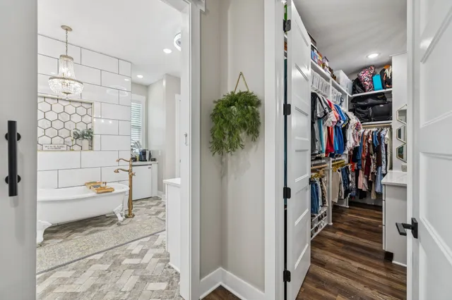 a view of balcony with a couple of cars parked on road in front of house