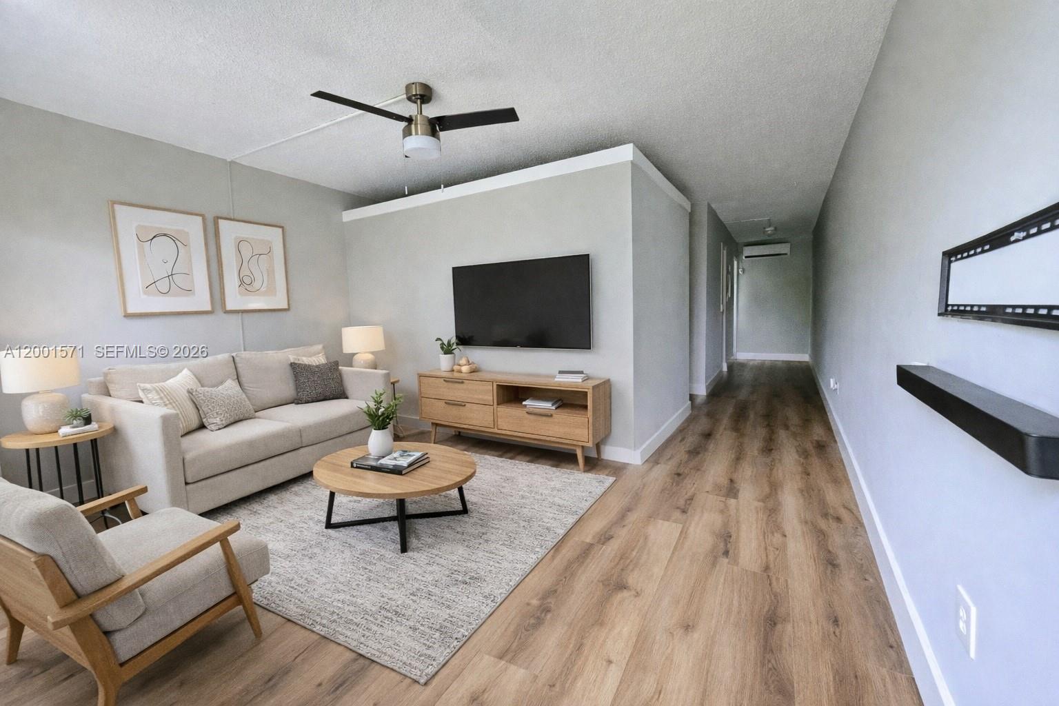 335 Southwest 20th Street, Unit 8 Fort Lauderdale, FL 33315 - Photo 1 of 11 a living room with furniture and a flat screen tv