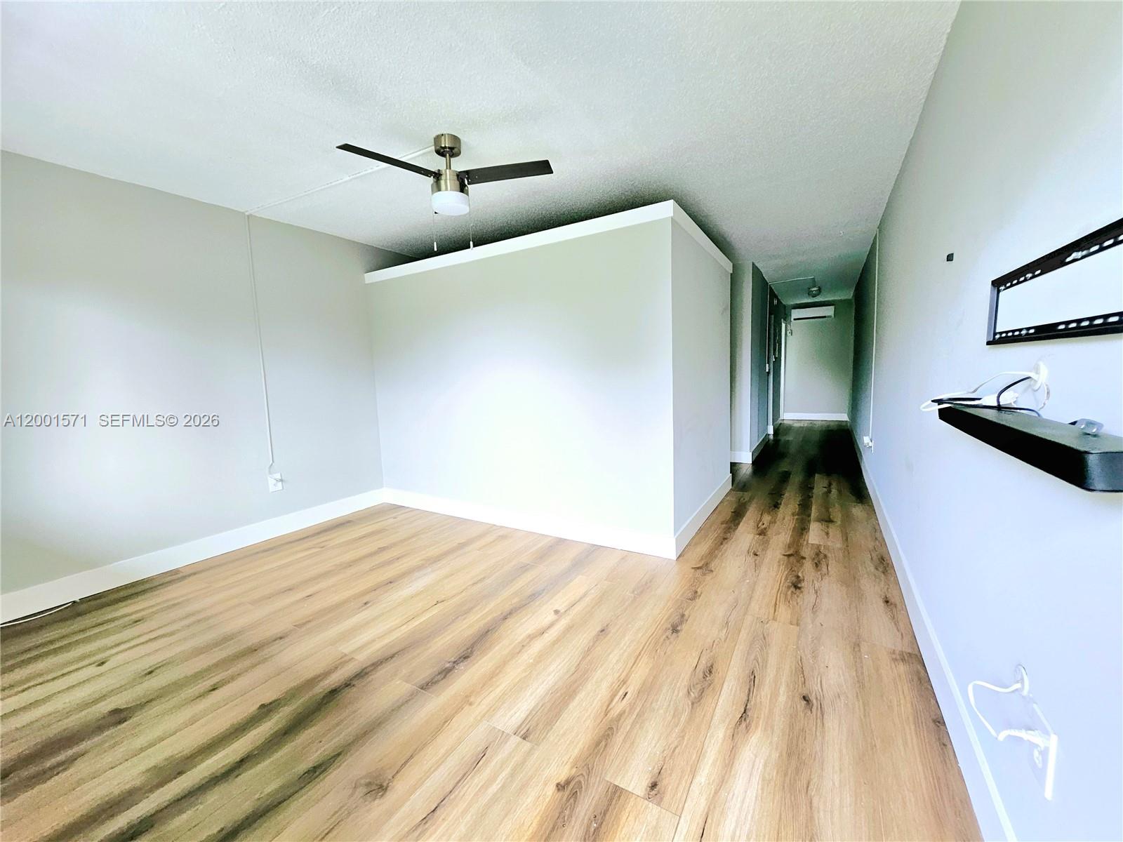 335 Southwest 20th Street, Unit 8 Fort Lauderdale, FL 33315 - Photo 2 of 11 a view of a bedroom with wooden floor and ceiling fan