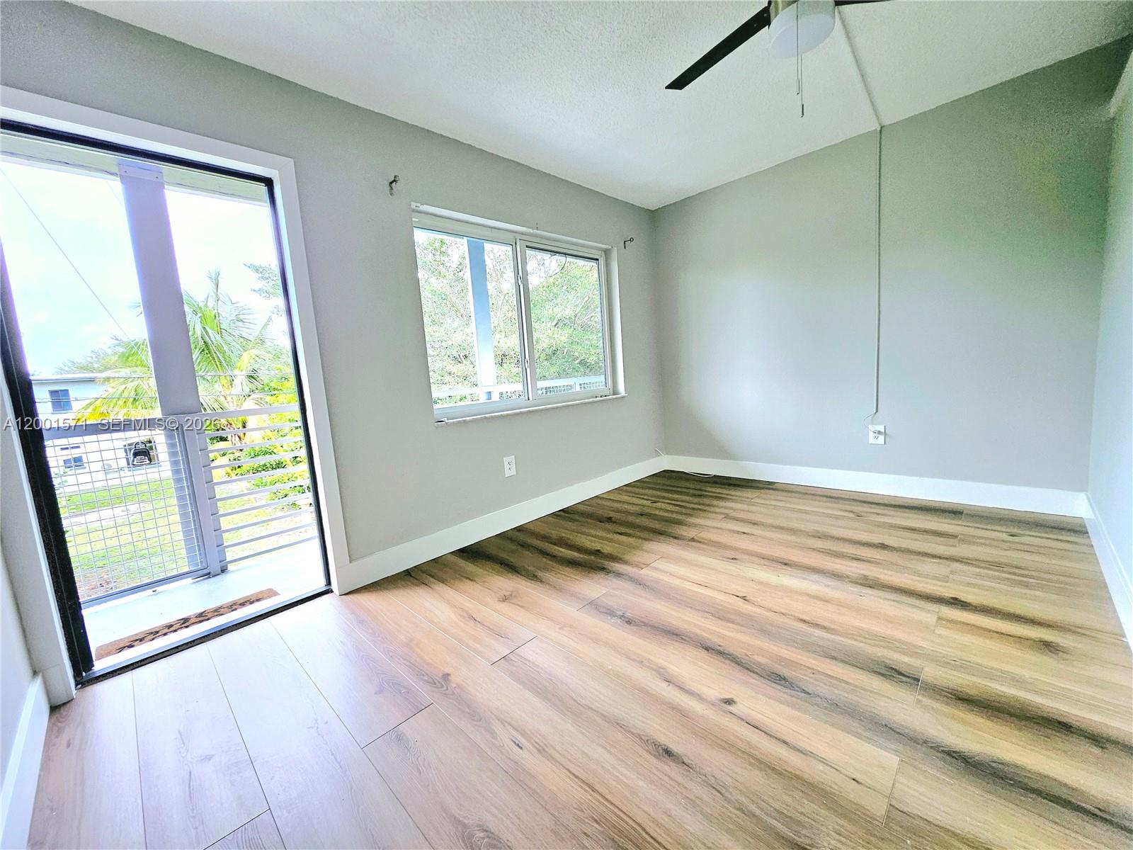 335 Southwest 20th Street, Unit 8 Fort Lauderdale, FL 33315 - Photo 3 of 11 a view of empty room with wooden floor and fan
